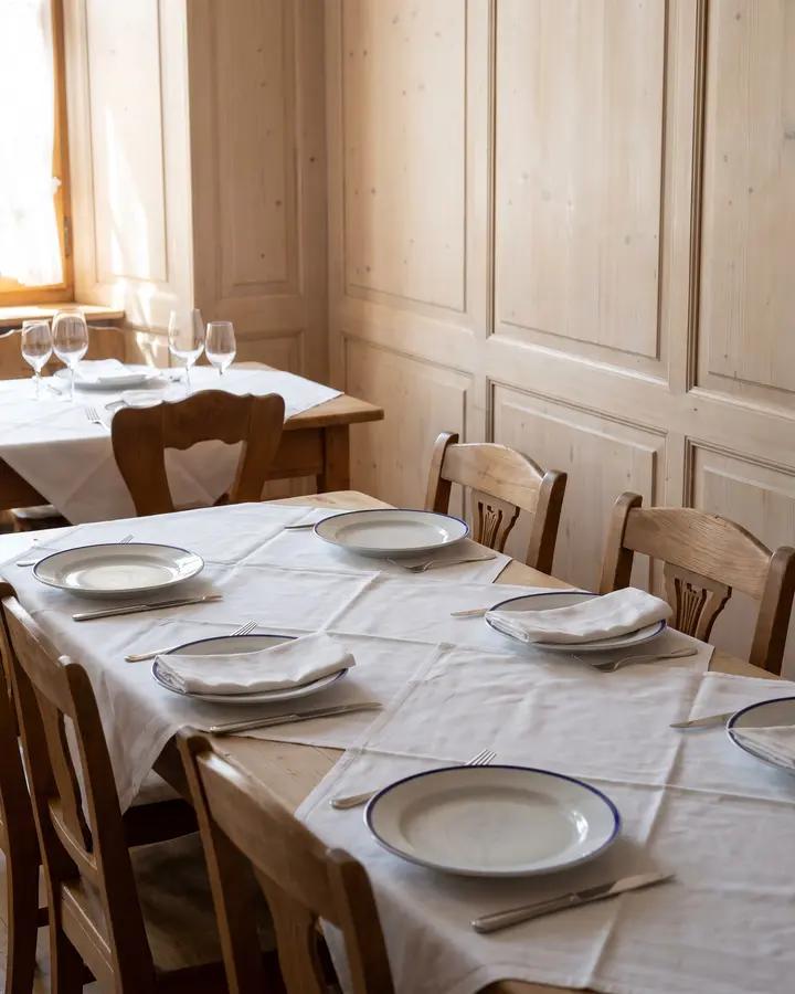 Die Tafel im Säli, gedeckt mit Leinen, Tellern und Gläsern